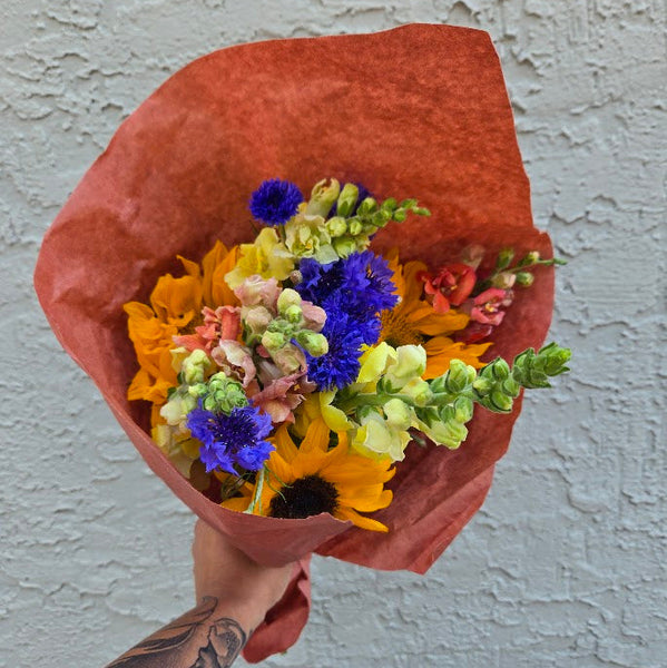 flower bouquet centered in front of textured wall